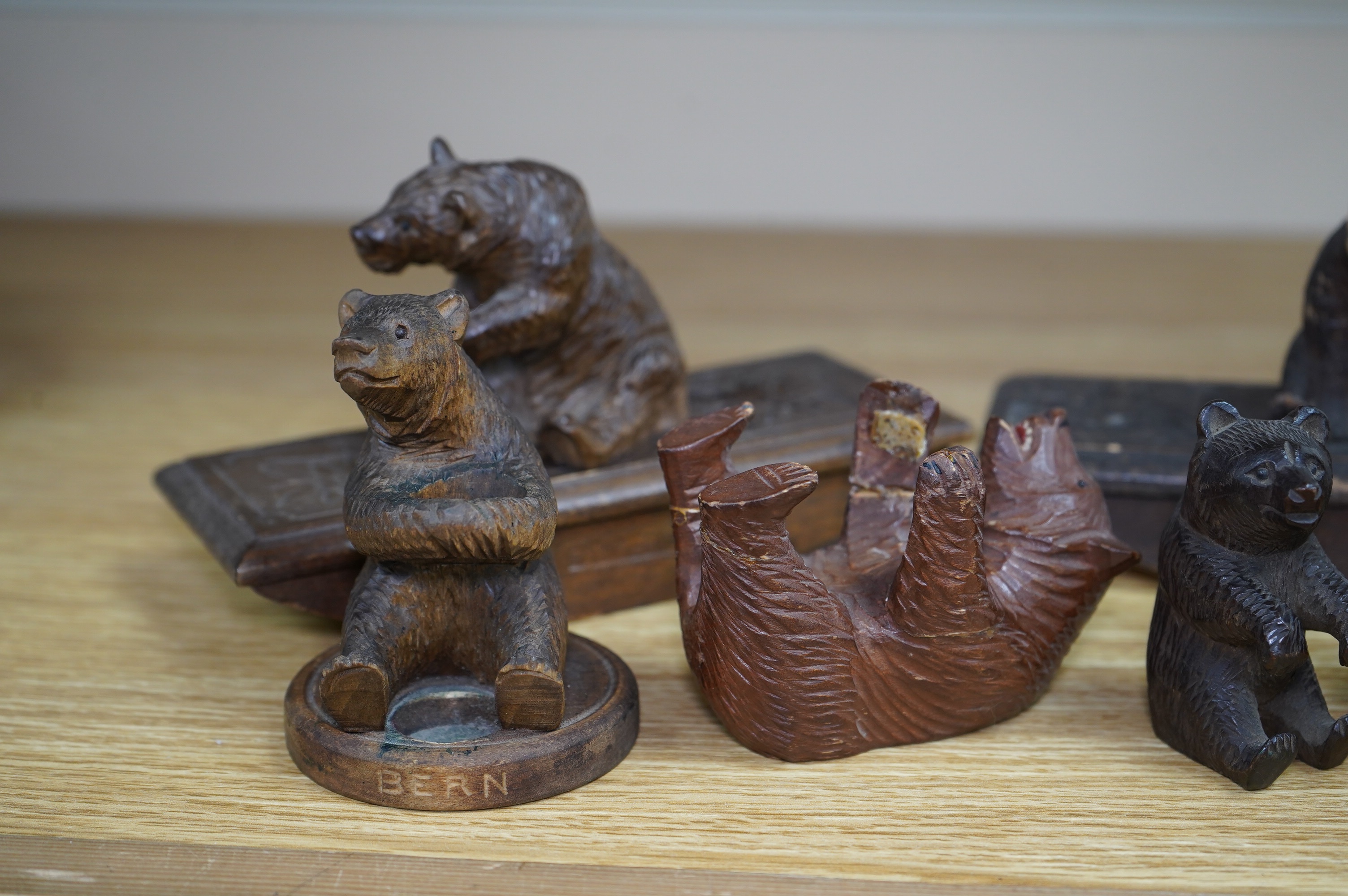 Five carved Black Forest bears, two in the form of ink blotters, together with an African figure of a hippopotamus, largest 17cm wide. Condition - poor to fair